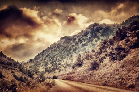 Grunge photo of road in the mountains