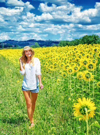 Walking on sunflowers field