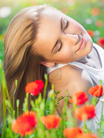 Beautiful woman on poppy flower field