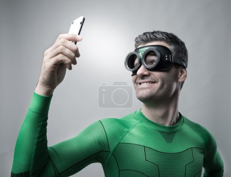 Superhero taking a selfie with a smartphone
