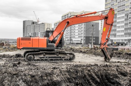Orange excavator on a construction site