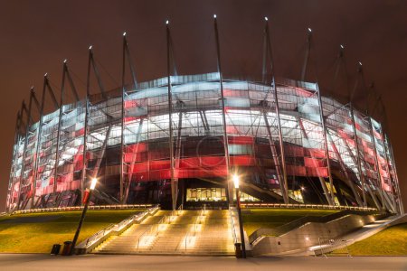 National Stadium in Warsaw illuminated at night by national colors, Poland