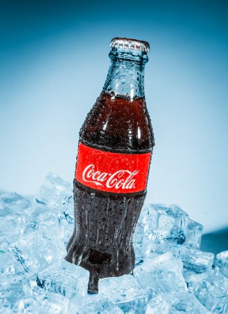 Bottle of Coca-Cola on ice.