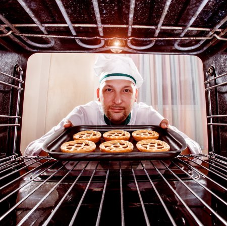 Chef prepares pastries in the oven