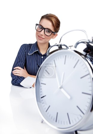 Young businesswoman with a big clock