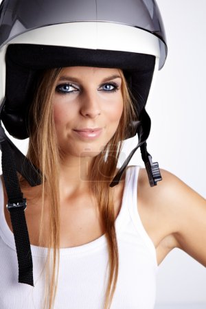 Sexy woman with a white motrcycle helmet and surprised expressio