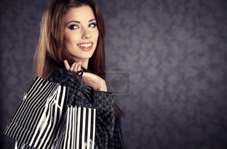 Portrait of young beautiful women with her shopping bags (retro