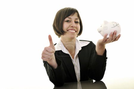 Business woman putting coins money in piggy bank