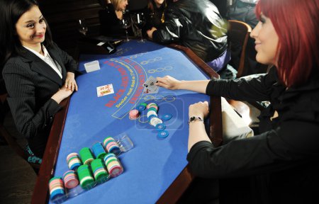 Woman play black jack card game in casino