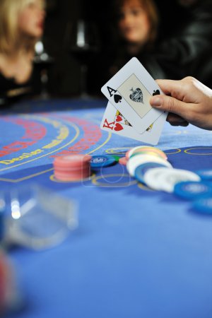Woman play black jack card game in casino