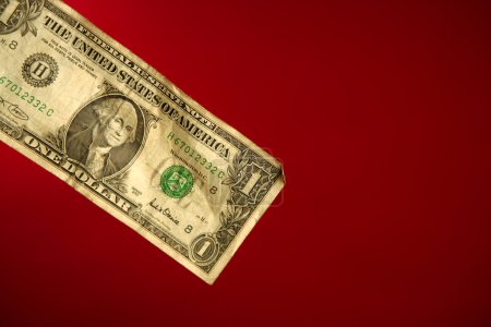 One dollar note over red background