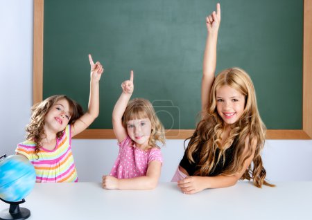 Kids student clever girls in classroom raising hand