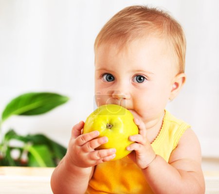 Little baby eating apple