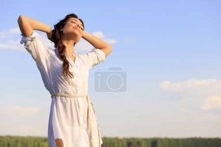 Young happy woman in green field