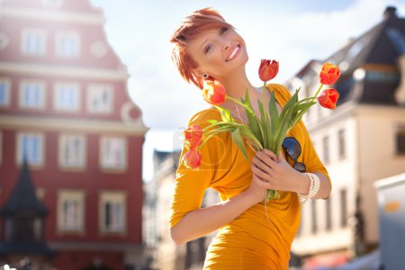 Happy woman with bunch of flowers