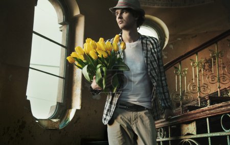 Romantic man holding bunch of tulips