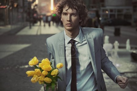 Attractive guy with bunch of tulips