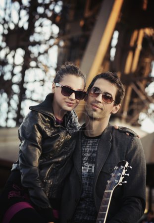 Handsome couple with sunglasses and guitar