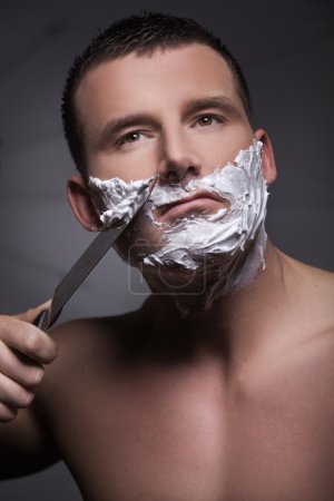 Shaving man using big knife