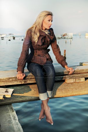 Girl sitting on a pier