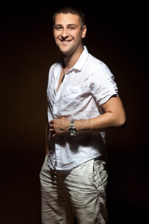 Smiling man posing in white shirt