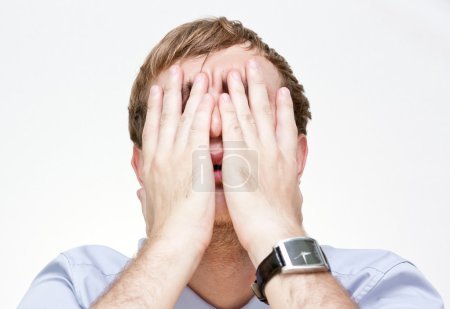 Portrait of a businessman covering the face with his hands