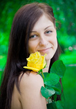 Portrait of a cute young female with flower