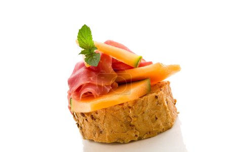 Ham and melon appetizer isolated