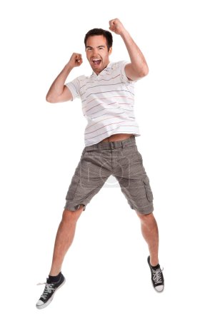 Young happy man jumping on a white