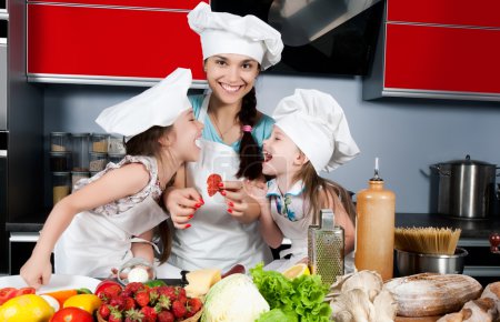 Mother and two daughters in the kitchen
