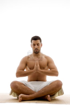 Man practicing yoga with closed eyes