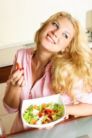 Pretty girl eating salad