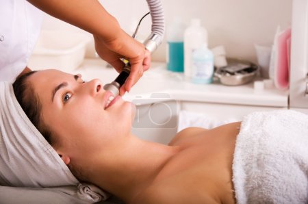 Young woman getting skin cleaning