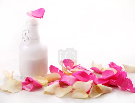 Bottle and rose petals