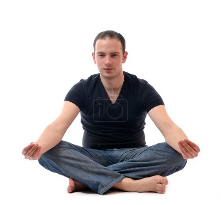 Young man in lotus position exercising yoga