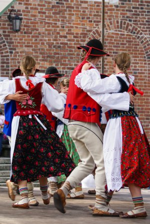 Horizontal colour image of female polish dancers in traditional 