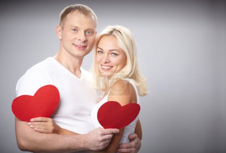 Couple with red paper hearts