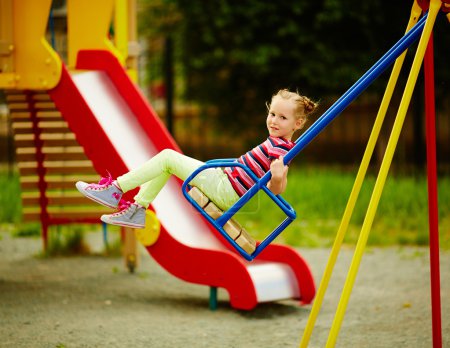 Girl swinging on playground