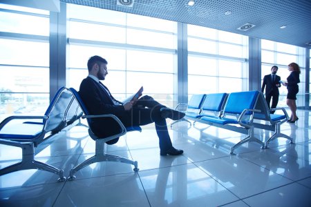 Businessman reading at the airport