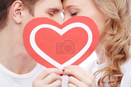 Happy couple holding Valentine heart