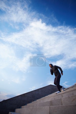 Sportsman running down steps