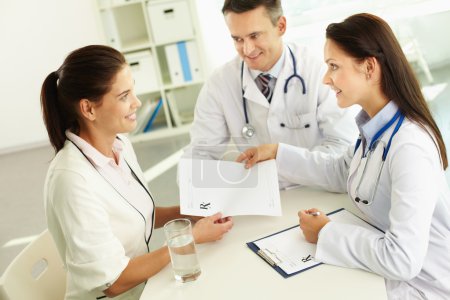 Practitioner giving blank paper to patient