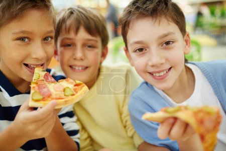 Boys enjoying pizza