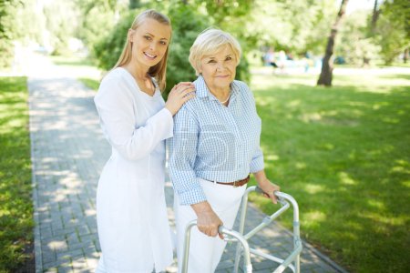 Nurse and senior patient with walking frame