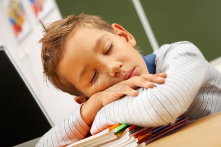Boy sleeping in classroom