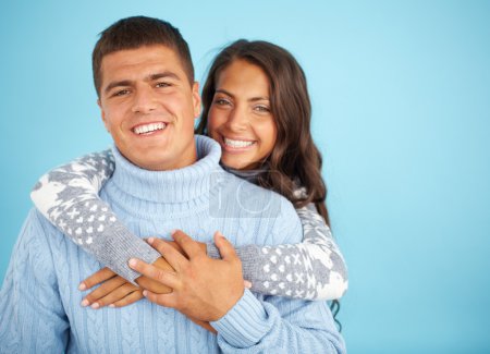 Couple in fashionable pullovers