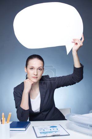 Businesswoman holding blank speech bubble