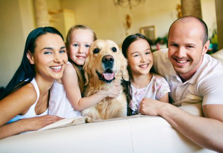 Friendly family of four with dog