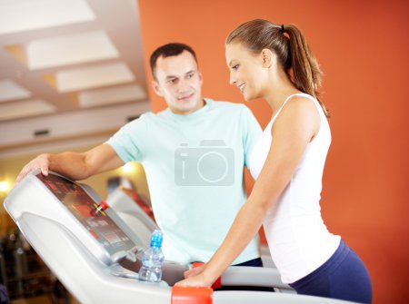 Girl in gym with her trainer