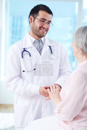 Doctor looking at his senior patient